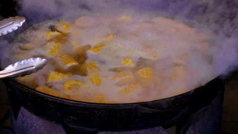Corn is boiled in a cauldron. Selective focus. Stock Footage 263898730