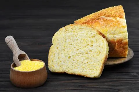 Corn bread and corn flour in wooden bowl Stock Photos