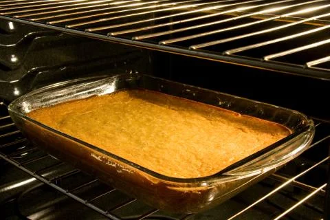 Corn cake baking in oven Stock Photos