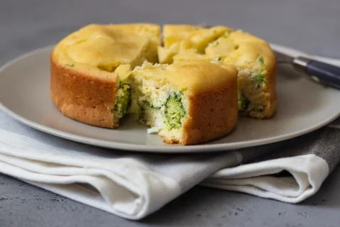 Corn cake with broccoli on parchment paper. Stock Photos