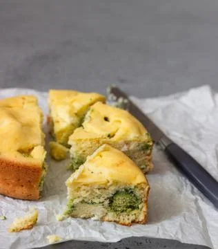 Corn cake with broccoli on parchment paper. Stock Photos