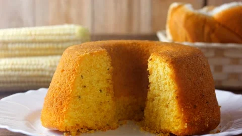 Corn cake sliced in basket on rustic wooden table for breakfast Stock Footage 145796440