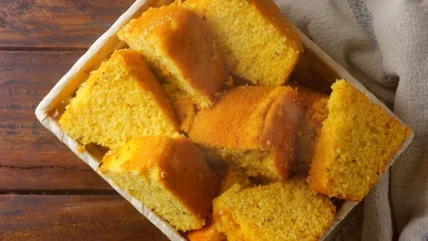 Corn cake sliced in basket on rustic wooden table for breakfast Stock Footage 145796442