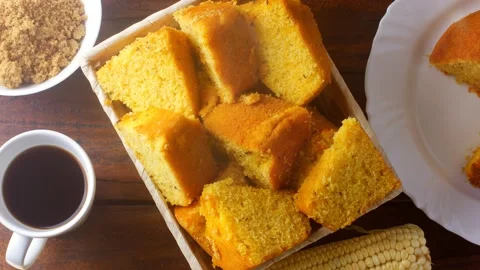 Corn cake sliced in basket on rustic wooden table for breakfast Stock Footage 145796443