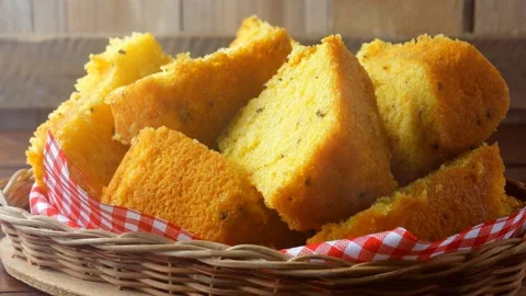 Corn cake sliced in basket on rustic wooden table for breakfast Stock Footage 145796444