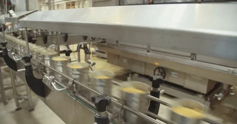 Corn in cans on a conveyor in a food processing facility Stock Footage