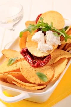 Corn chips, feta and sun dried tomatoes Stock Photos