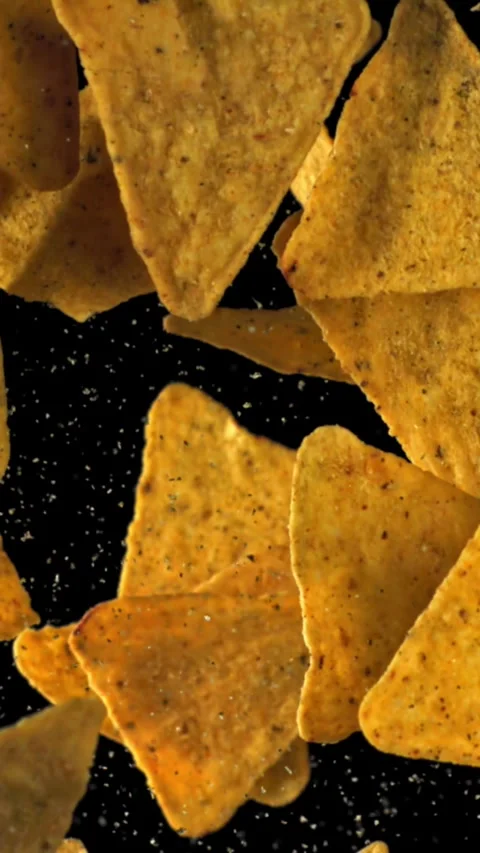 Corn chips fly up and fall down. Filmed on a high-speed camera at 1000 fps Stock Footage 335368640