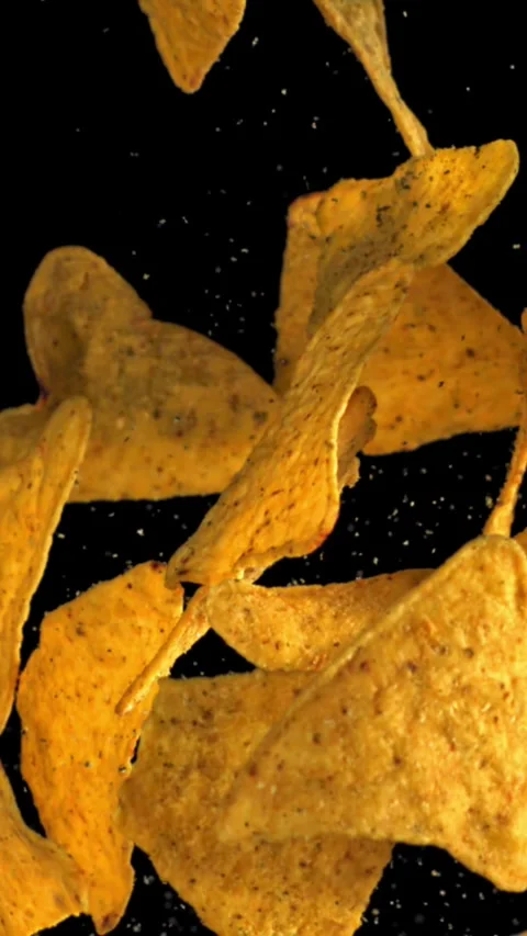 Corn chips fly up and fall down. Filmed on a high-speed camera at 1000 fps Stock Footage 335371120