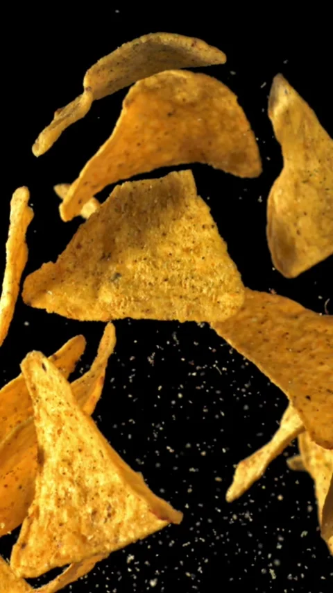 Corn chips fly up and fall down. Filmed on a high-speed camera at 1000 fps Stock Footage 335376514
