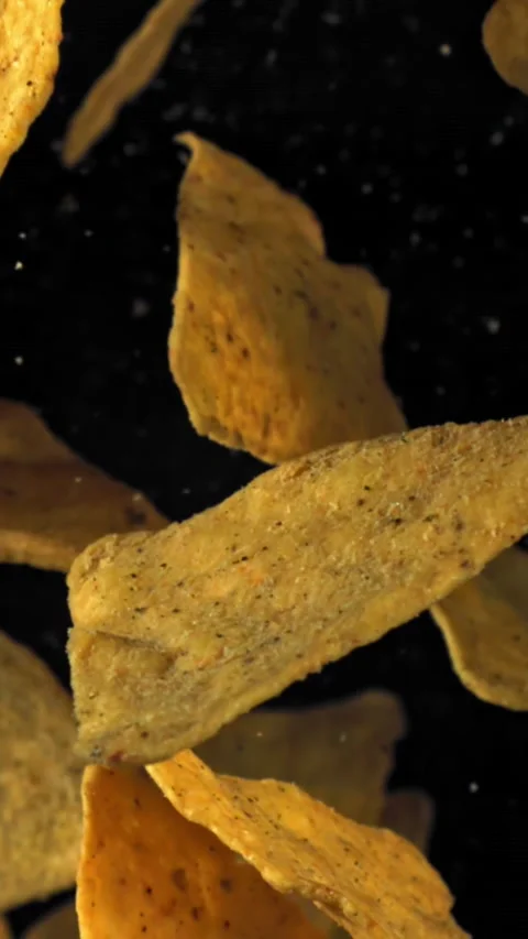 Corn chips fly up and fall down. Filmed on a high-speed camera at 1000 fps Stock Footage 335376853