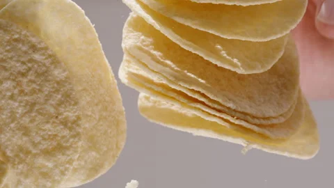 Corn chips in the shape of a saddle, view from below through a glass table. Hand Video stock 261017967
