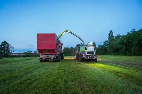 Corn chopper at night Claas Jaguar silage harvest Stock Photos