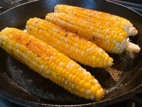 Corn on the Cob Cooking in Cast Iron Skillet Stock Photos
