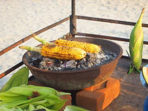 Corn on the cob is fried on coals with aromatic spices. Delicious and healthy Stock Photos