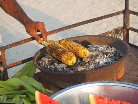 Corn on the cob is fried on coals with aromatic spices. Delicious and healthy Stock Photos