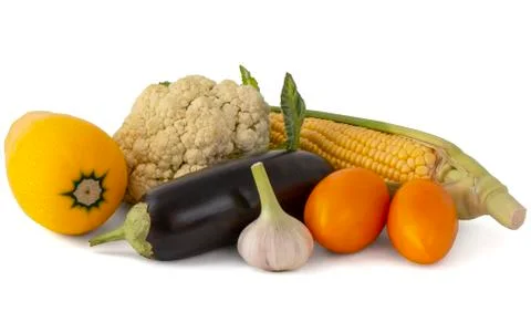 Corn on the cob squash a couple of tomatoes eggplant and broccoli Stock Photos