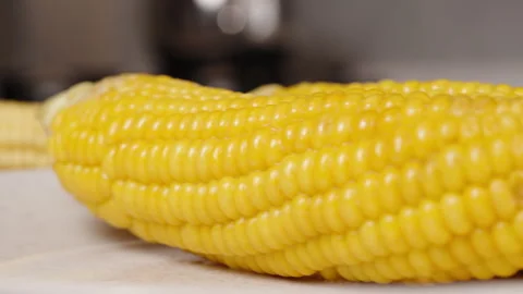 Corn cobs are placed on the table, with ... | Stock Video | Pond5
