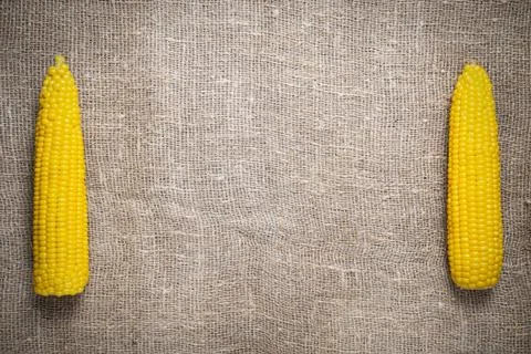 Corn cobs on an old craft dress with a large weaving Stock Photos