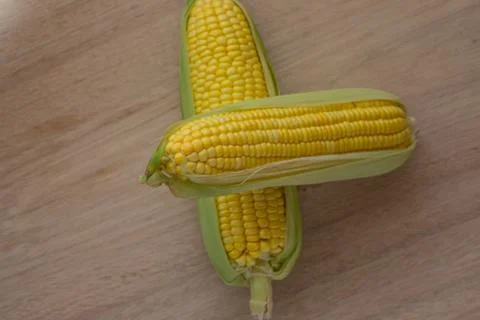 Corn cobs on wood background Stock Photos