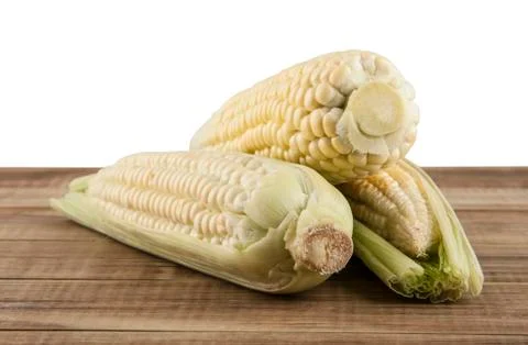 Corn cobs on a wooden table Stock Photos