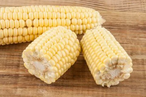 Corn cobs on a wooden table 스톡 사진