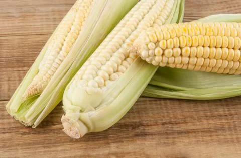 Corn cobs on a wooden table Stock Photos
