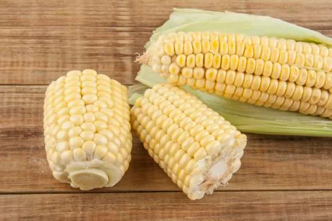 Corn cobs on a wooden table Stock Photos