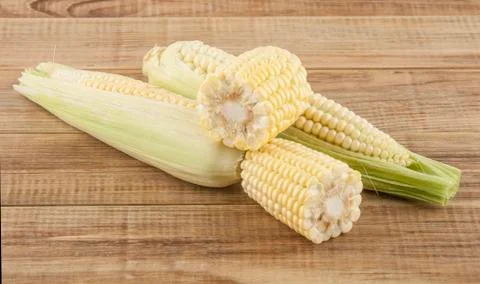 Corn cobs on a wooden table Stock Photos