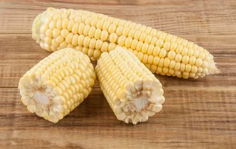 Corn cobs on a wooden table Stock Photos