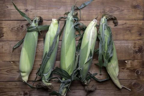 Corn on cobs on wooden table.Top view. Stock Photos