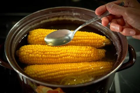 Corn is cooked in a pan in the kitchen, cafe Stock Photos