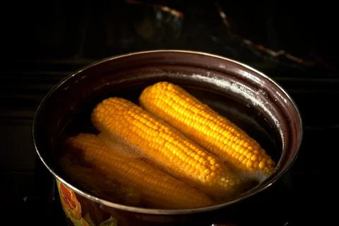 Corn is cooked in a pan in the kitchen, cafe Stock Photos