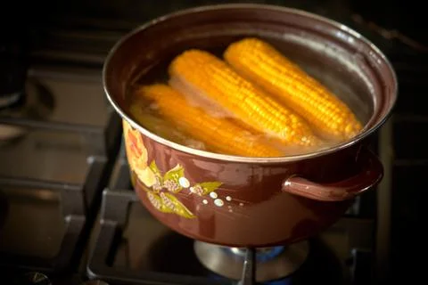Corn is cooked in a pan in the kitchen, cafe Stock Photos