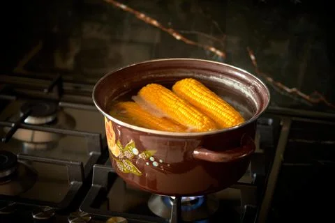 Corn is cooked in a pan in the kitchen, cafe Stock Photos