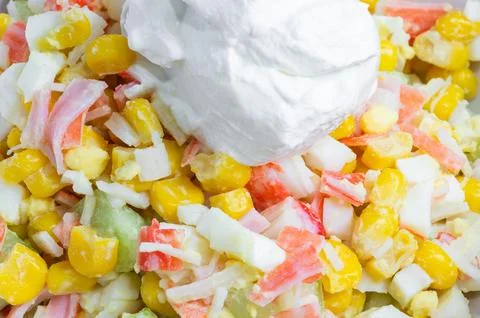 Corn, crab stick, and egg salad with sour cream. Close-up of crab salad. Foto stock