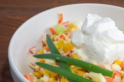 Corn, crab stick, and egg salad with sour cream. Close-up of crab salad. Stock Photos
