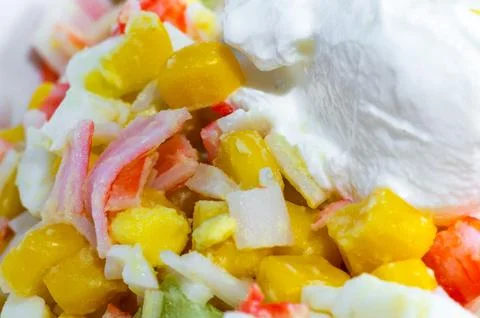 Corn, crab stick, and egg salad with sour cream. Close-up of crab salad. Stock Photos