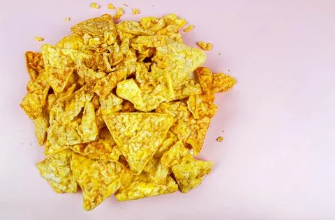 Corn crumbs on a pink background Stock Photos