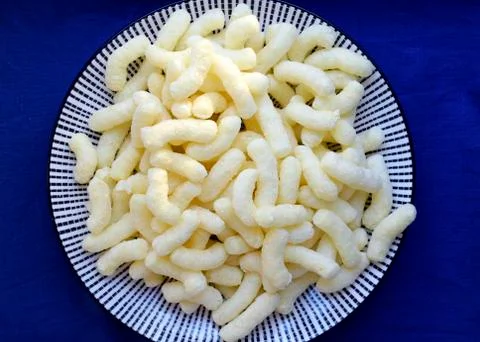 Corn curls on the plate Stock Photos