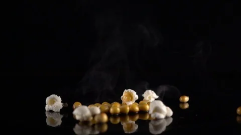 Corn exploding on a black surface Stock Footage 73679824
