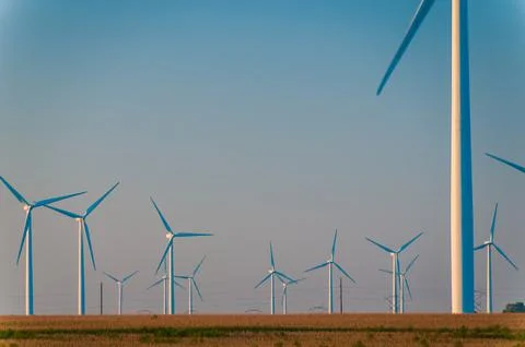 A corn field with large wind turbines against a blue sky at sunset, Dexter, M Stock Photos