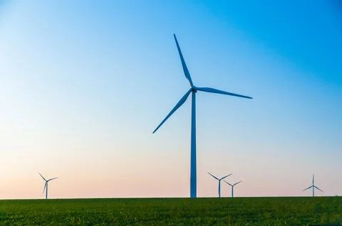 A corn field with large wind turbines against a blue sky at sunset, Dexter, M Stock Photos