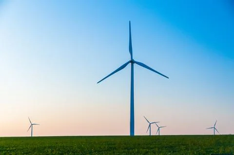 A corn field with large wind turbines against a blue sky at sunset, Dexter, M Stock Photos