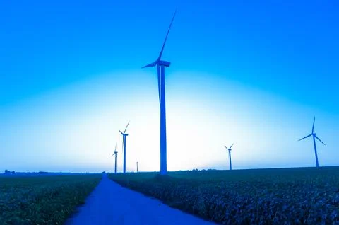 A corn field with large wind turbines against a blue sky at sunset, Dexter, M Stock Photos