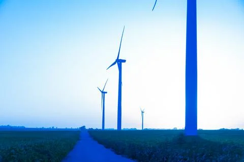 A corn field with large wind turbines against a blue sky at sunset, Dexter, M Stock Photos