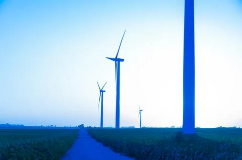 A corn field with large wind turbines against a blue sky at sunset, Dexter, M Stock Photos