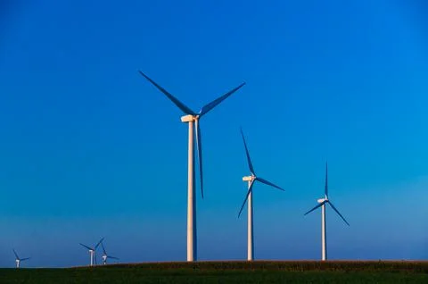 A corn field with large wind turbines against a blue sky at sunset, Dexter, M Stock Photos