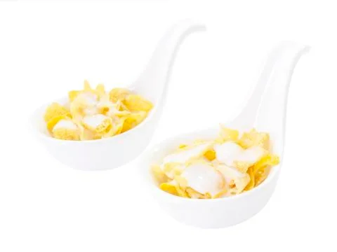 Corn flake with milk in spoon Stock Photos
