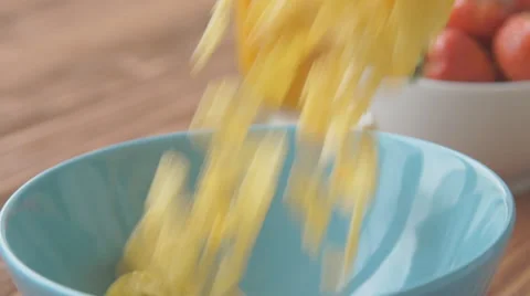 Corn flakes and milk falling in a bowl, slow motion Stock Footage 68951186